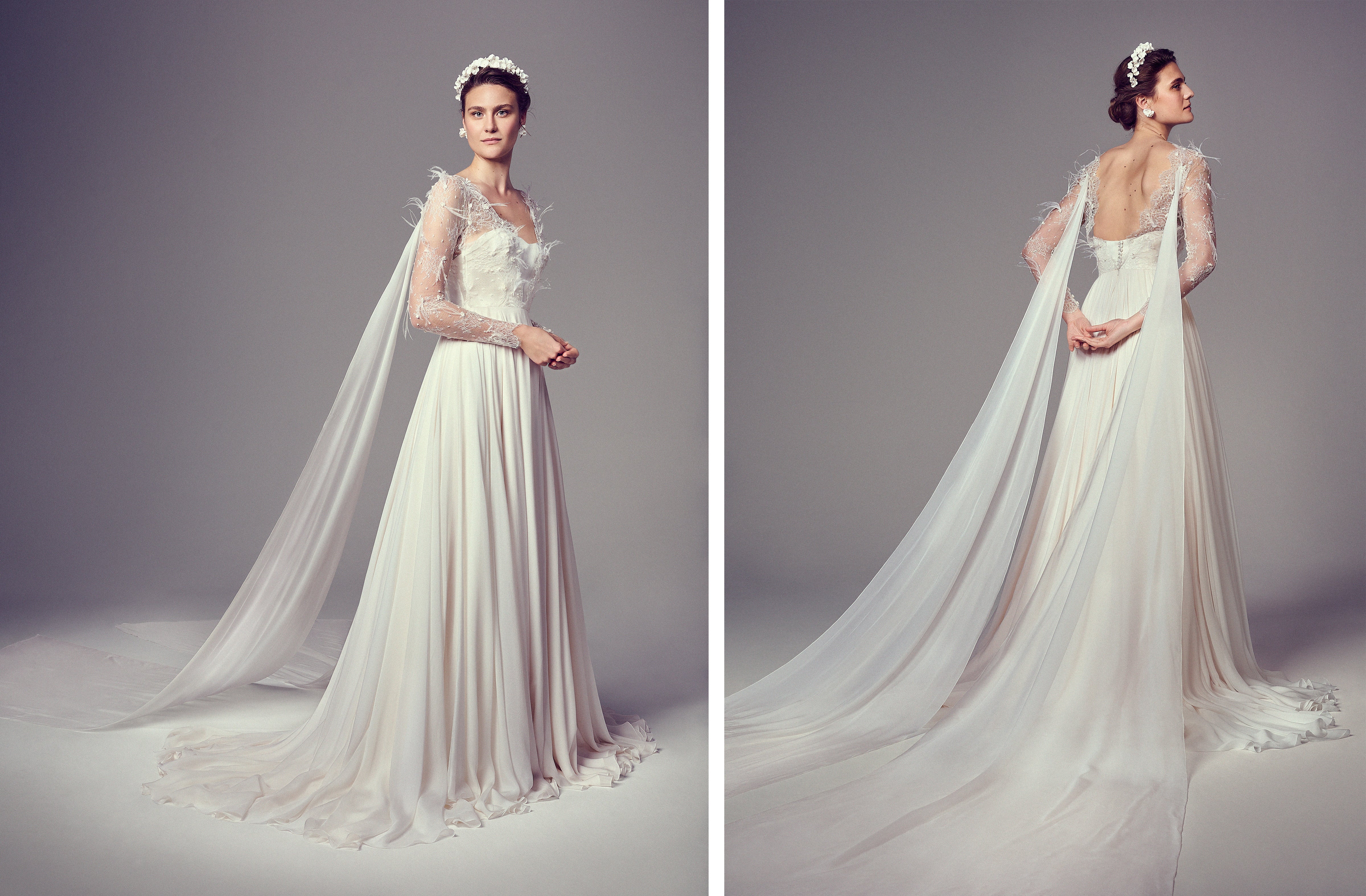 Model wearing a custom, bespoke, made-to-order bridal gown with sheer long sleeves, feathered floral embroidery, and silk chiffon streamers flowing from each shoulder into a cathedral-length train. The gown features a soft scoop neckline and low back.